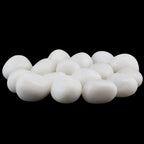 Un groupe d'agates blanches roulées aux surfaces lisses et d'un blanc pur éclatant, dont les formes arrondies contrastent fortement avec un fond noir uni.