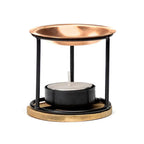 Brûle-parfum en métal noir et cuivré avec coupelle ronde, bougie chauffe-plat au centre, présenté sur fond blanc.