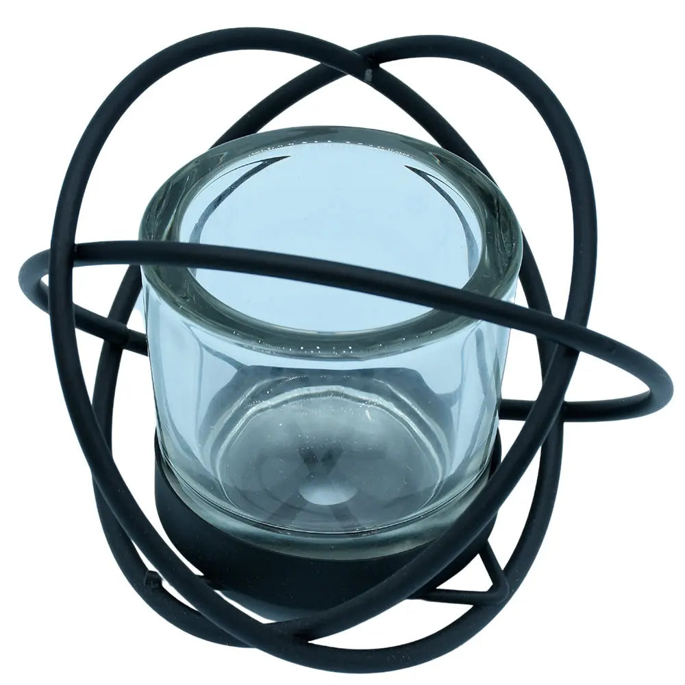 Un photophore moderne composé d'un récipient en verre transparent inséré dans une structure décorative en métal noir formée d'anneaux entrelacés, présenté sur un fond blanc.