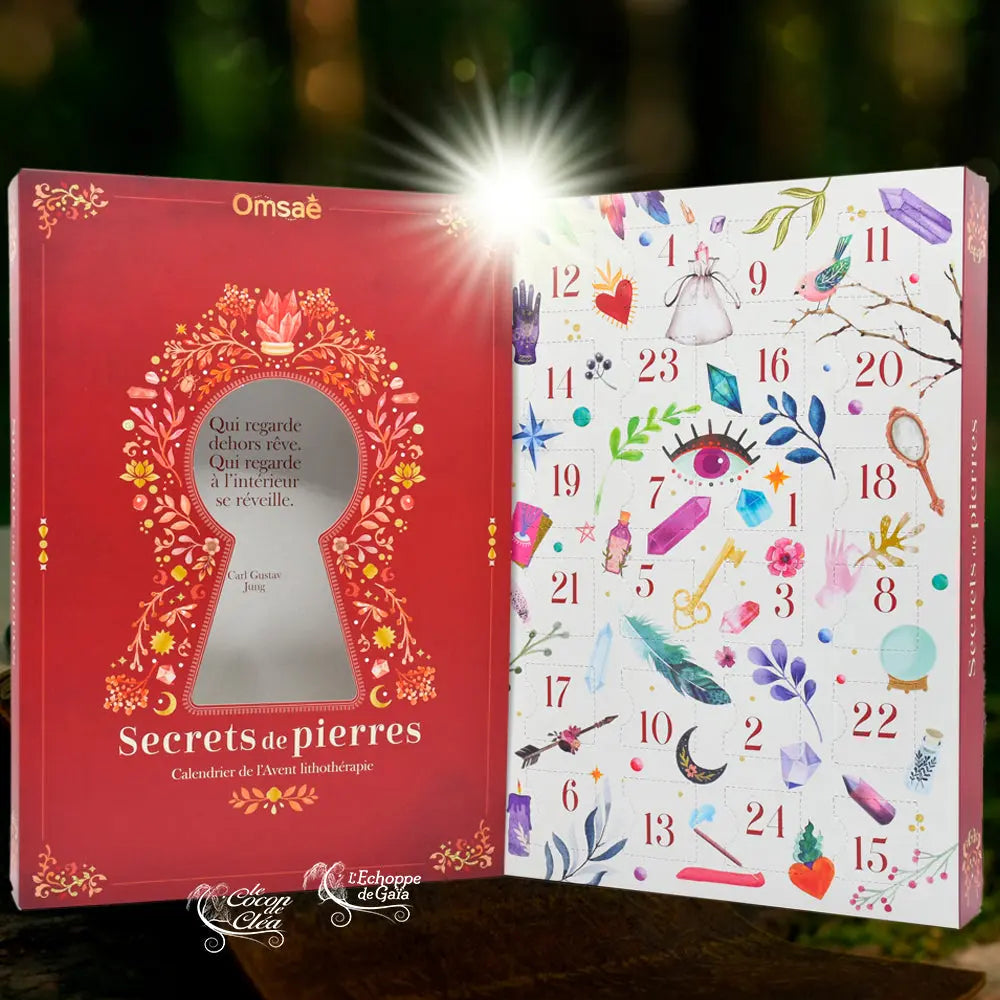 Vue ouverte du calendrier de l'Avent "Secrets de pierres", montrant la couverture rouge illustrée et les 24 cases numérotées décorées de motifs ésotériques colorés.