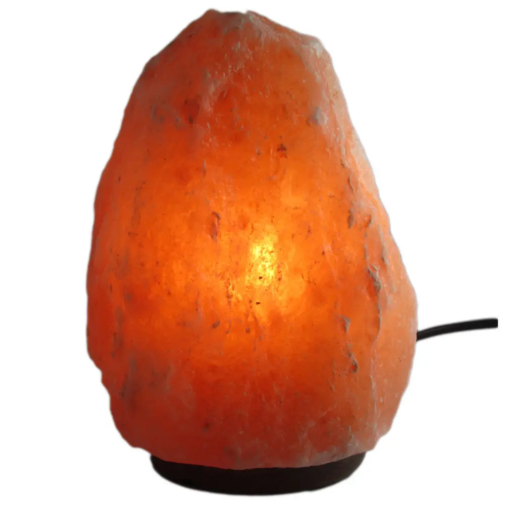 Lampe en sel de l'Himalaya de forme brute sur un socle noir, avec son câble d'alimentation sur le côté.