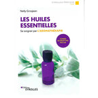 Les Huiles Essentielles - Se soigner par l'Aromathérapie de Nelly Grosjean, sa couverture blanche illustrant un petit flacon violet opaque posé devant des feuilles vertes vaporeuses.