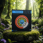Livre Mandalas Celtes - Margot Grinbaum & Théo Lahille sur mousse sacrée au pied d'un arbre, entouré de fleurs violettes sous des rayons de soleil magiques.