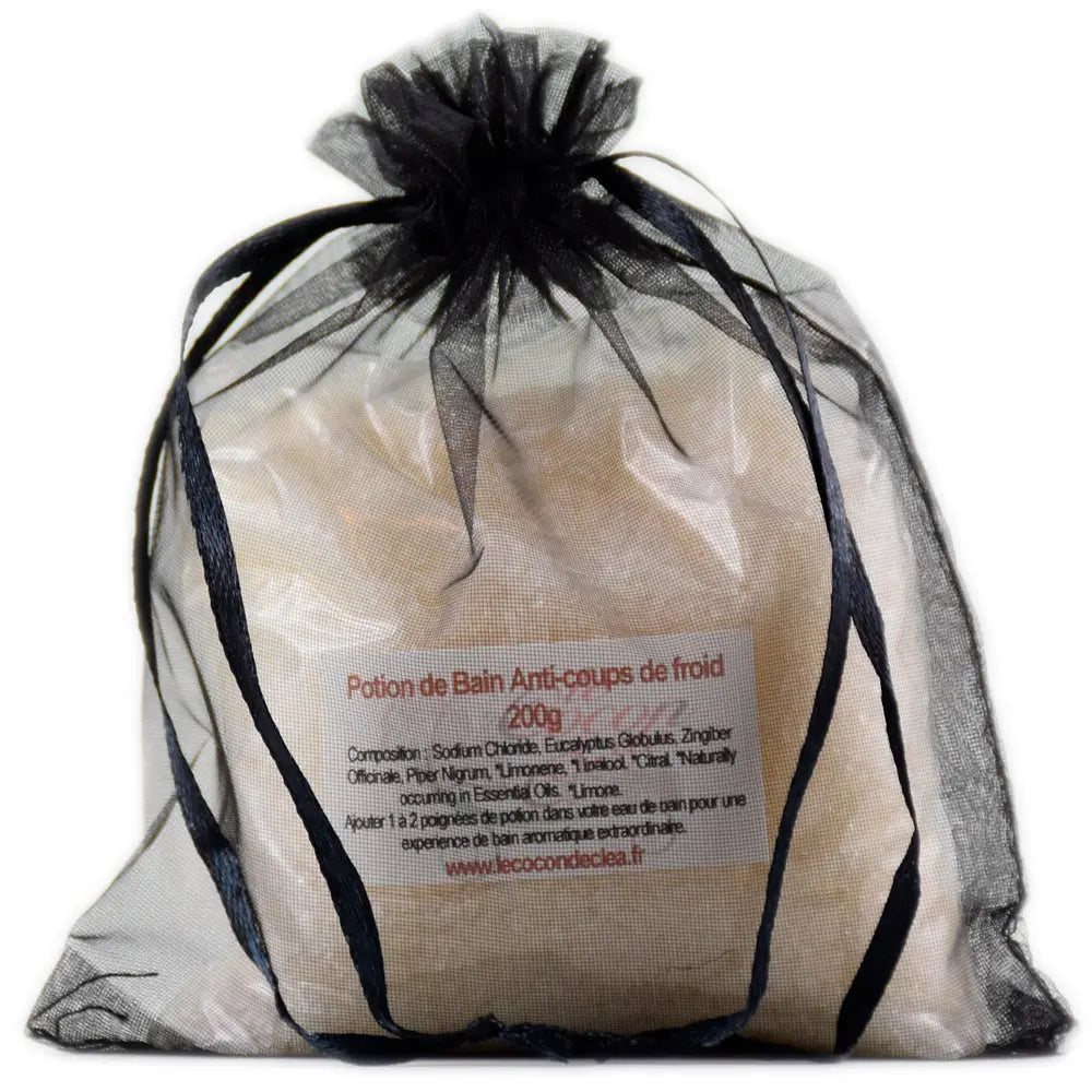 Sachet en organza noir rempli de sels de la Potion de bain Anti-coups de froid sur fond blanc.