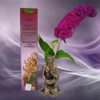 Boîte d'encens naturel Vedic Saint Joseph Santal rose avec illustration du saint tenant l'enfant Jésus, statuette de moine et fleur violette sur fond mauve